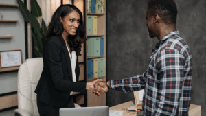 a woman shaking hands with a man
