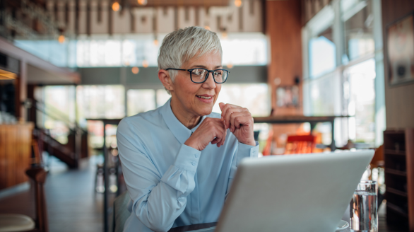 A professional woman sitting at a computer.